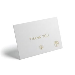 awhitethankyoucardwithgoldfoilleafandgiftboxdesignsonawhitebackground.jpg